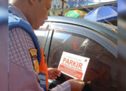Petugas Dishub Kota Sukabumi Pasang Stiker di Mobil Parkir Sembarangan di Jalan Ahmad Yani