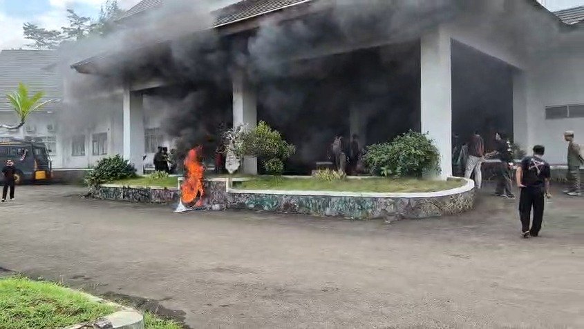 Asap hitam mengepul saat massa dari Aliansi Kaum Muda Sukabumi Melawan menggelar aksi unjuk rasa di depan Gedung DPRD Kabupaten Sukabumi, Senin (06/04/2026).